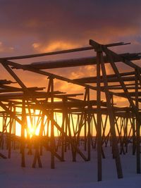 Silhouette built structure against sky during sunset