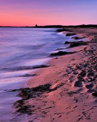 Scenic view of beach at sunset