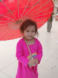 Cute girl holding umbrella outdoors