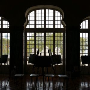 Empty chairs and tables in building