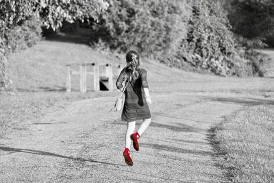 Full length of woman on dirt road