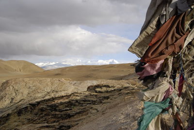 Clothes hanging on mountain against sky