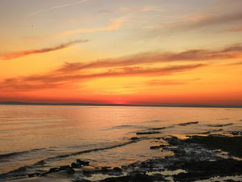 Scenic view of sea against romantic sky at sunset