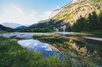 Scenic view of lake and mountains against sky