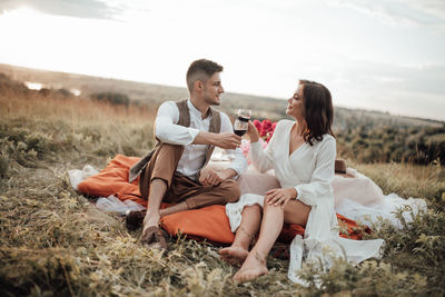 Young couple sitting on land