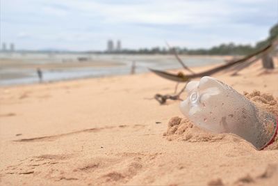 Close-up bottle plastic garbage on the beach created by some of the most stubborn tourists. 