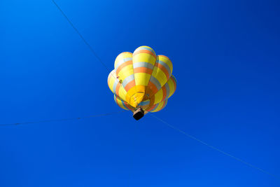 Low angle view of hot air balloon against blue sky