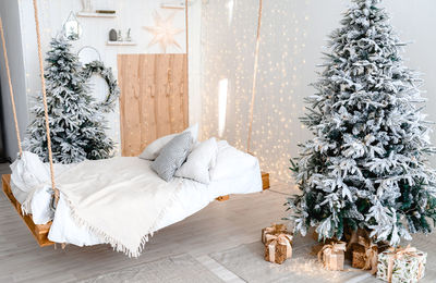 White bedroom apartments decorating christmas tree and shine light