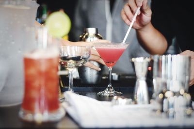 Cropped image of men with drink at bar counter
