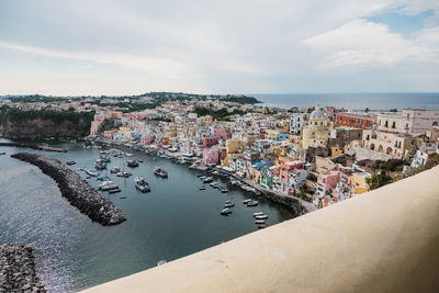 High angle view of townscape by sea against sky