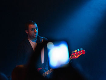 Young man playing in music concert