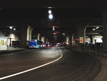 Road in illuminated bridge at night
