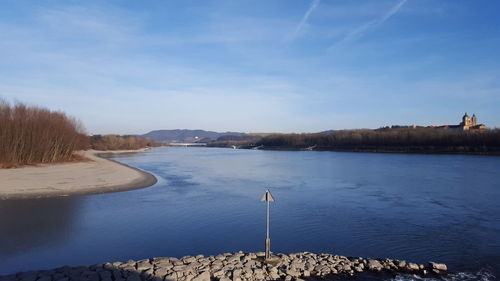 Scenic view of calm lake against blue sky