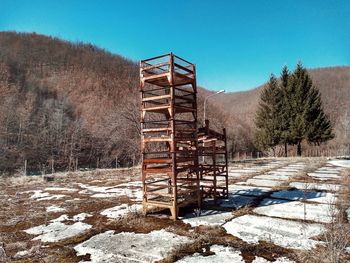 Built structure on field against clear sky during winter