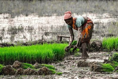 Side view of man working in mud