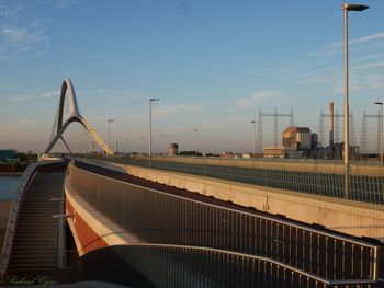 Bridge over river against sky during sunset