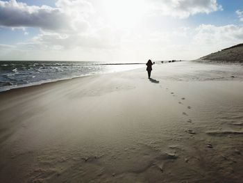 Full length of man on beach against sky