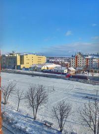 Snow covered city against sky