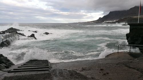 Scenic view of sea against cloudy sky