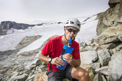 Mountaineer water from bottle with a filter attached.