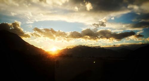 Scenic view of silhouette mountains against sky during sunset