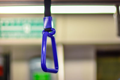 Close-up of blue metal hanging on rope