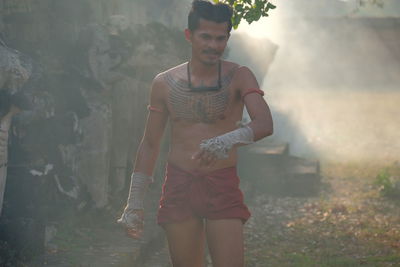 Full length of young man standing outdoors