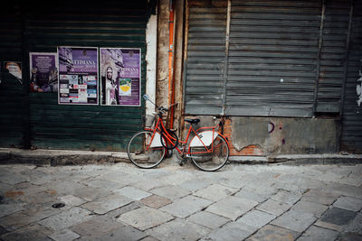 Bicycle on footpath against building