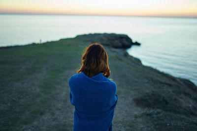 Rear view of woman looking at sea shore