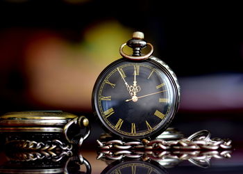 Close-up of pocket watches on table