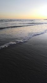 Scenic view of beach against sky during sunset