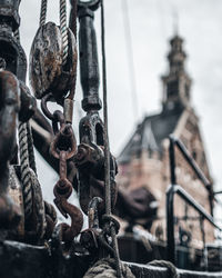 Close-up of rusty chain against sky