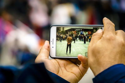 Midsection of man using mobile phone