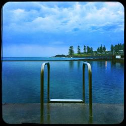 Scenic view of lake against cloudy sky