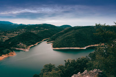 Scenic view of lake and mountains against sky