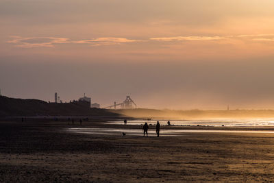 Scenic view of beach against sky during sunset