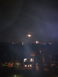 High angle view of illuminated buildings against sky at night