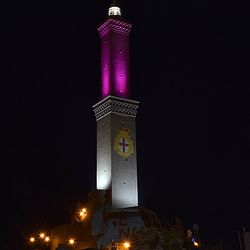 Low angle view of clock tower at night