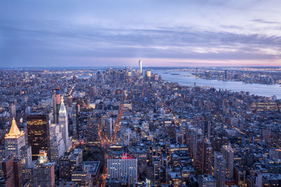 Aerial view of city lit up at night