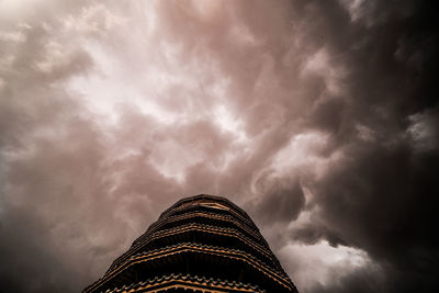 Low angle view of building against cloudy sky