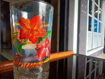 Close-up of red flower in glass container