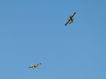 Low angle view of airplane flying in sky