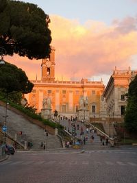View of buildings in city at sunset