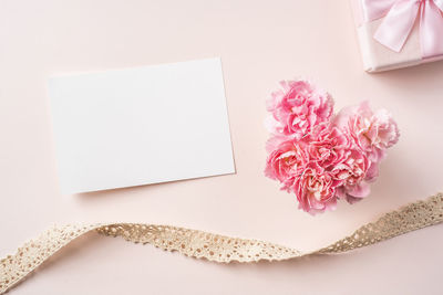 High angle view of pink flower on white table