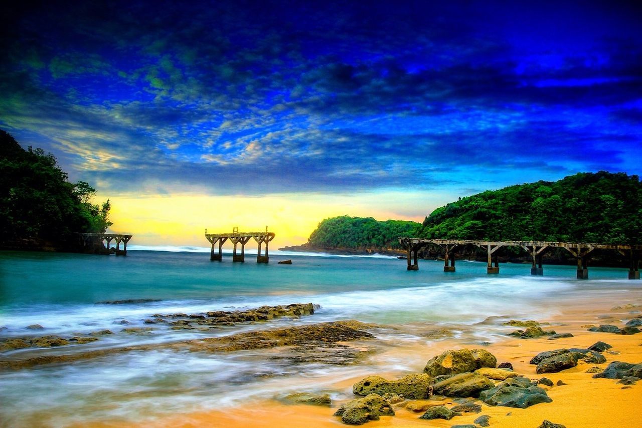 beach, water, sea, sky, scenics, beauty in nature, tranquil scene, shore, tranquility, cloud - sky, sand, nature, idyllic, horizon over water, tree, wave, incidental people, cloud, vacations, blue