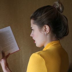 Close-up of woman reading book