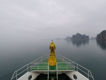 Boat in bay against sky