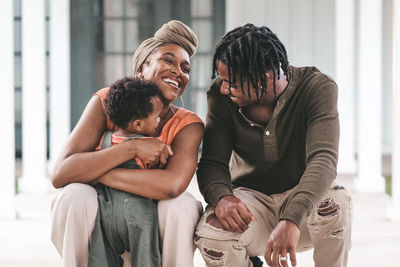Rear view of friends sitting outdoors