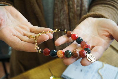 Artist holding handmade jewelry