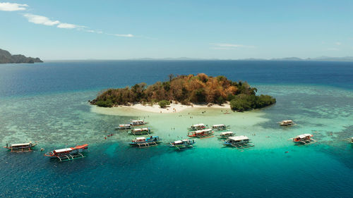 Aerial view tropical island with sand white beach, clear and blue water. cyc beach, philippines